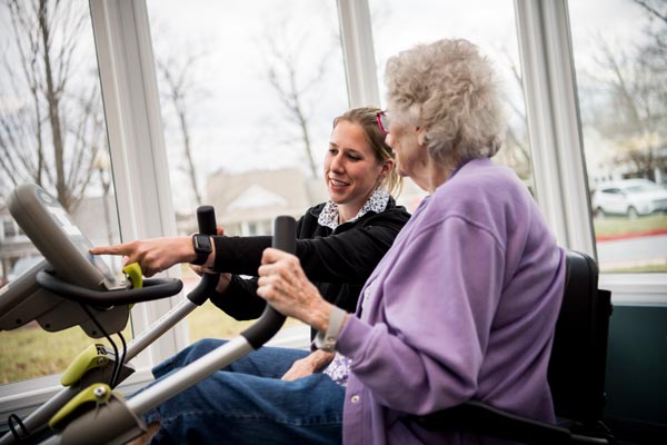 Rehab nurse with woman in purple